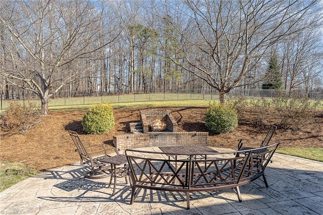 view of patio featuring an outdoor brick fireplace