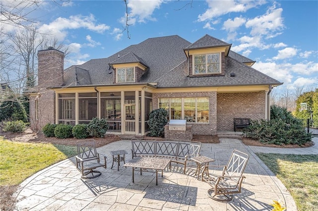 back of property with a sunroom and a patio