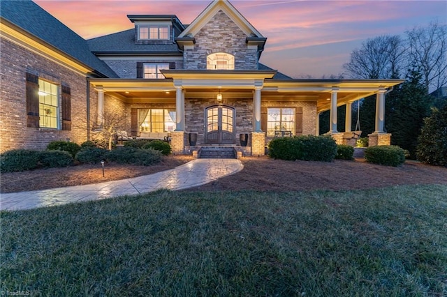 craftsman-style house with a porch and a lawn