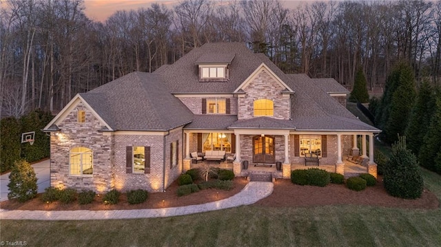 view of front of property with an outdoor living space, a patio, and a lawn