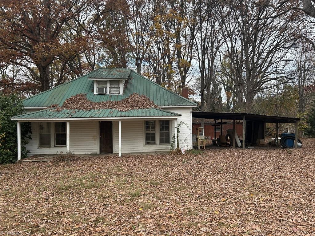 view of outbuilding with covered porch and a carport