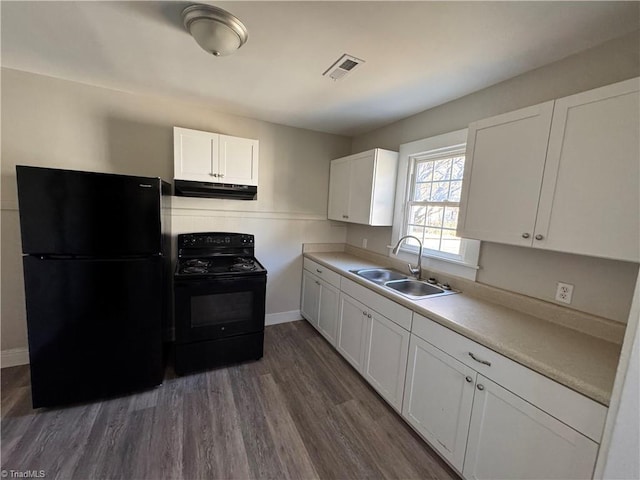 kitchen featuring white cabinetry, dark hardwood / wood-style flooring, black appliances, and sink