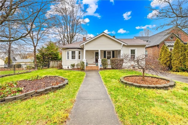 view of front of home with a porch and a front yard