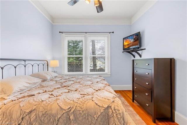 bedroom with light hardwood / wood-style flooring and ceiling fan