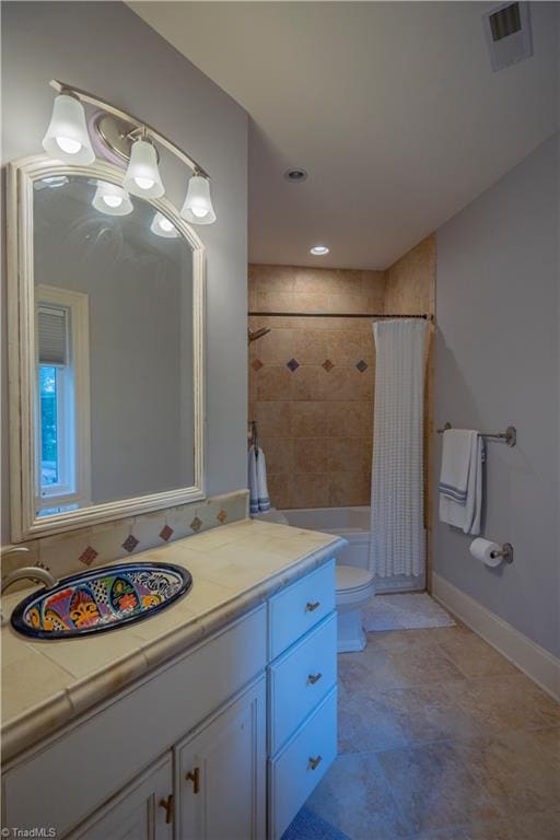 full bathroom featuring shower / bath combination with curtain, vanity, and toilet