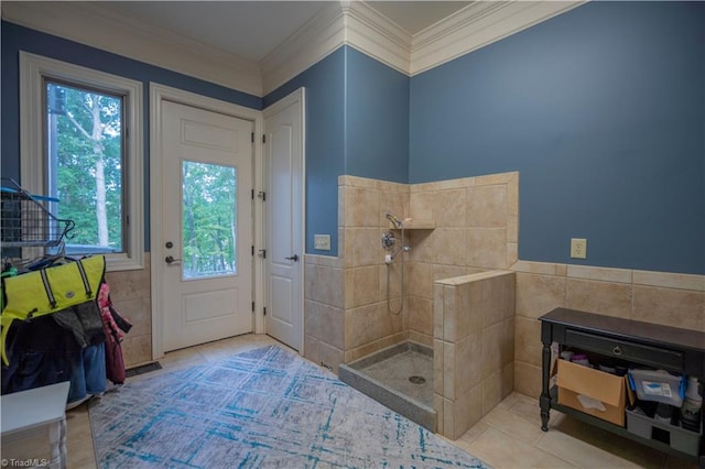 bathroom with tile patterned flooring, walk in shower, ornamental molding, and tile walls