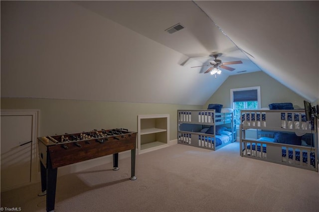 playroom featuring ceiling fan, built in features, vaulted ceiling, and carpet