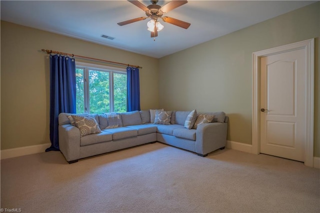 carpeted living room with ceiling fan