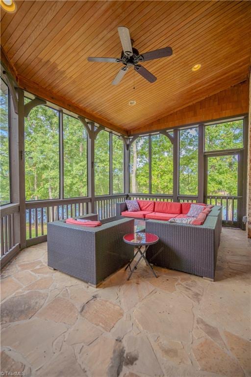 unfurnished sunroom featuring ceiling fan, lofted ceiling, and wood ceiling