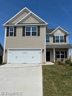 258 Plains Dr Lot # 315, Burlington, NC 27217 - view of front facade with a garage, concrete driveway, and a front yard