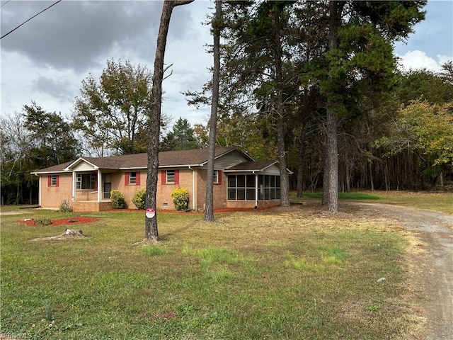 ranch-style home with a sunroom and a front lawn