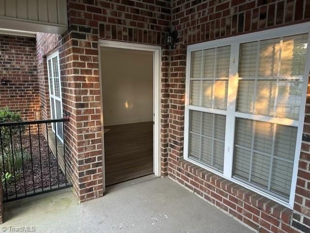 entrance to property with board and batten siding and brick siding