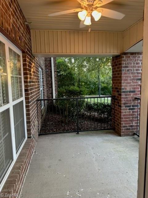 view of patio / terrace with a balcony and a ceiling fan