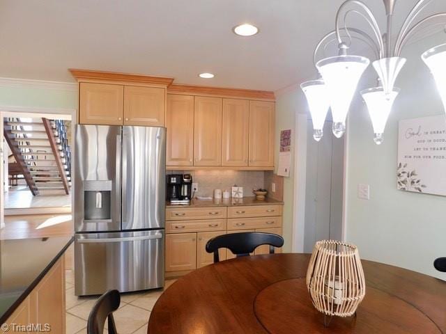 kitchen featuring light brown cabinetry, tasteful backsplash, stainless steel fridge, ornamental molding, and light tile patterned floors