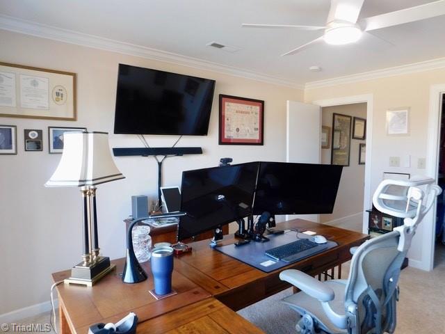 office area with ceiling fan, ornamental molding, and carpet flooring