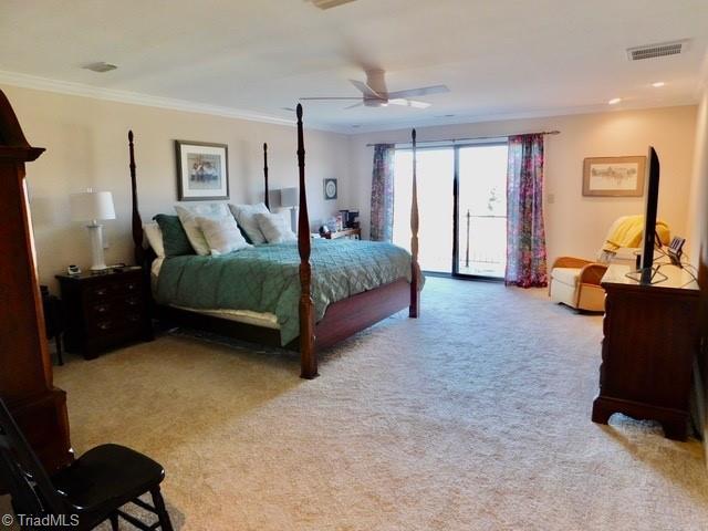 bedroom with crown molding, ceiling fan, access to exterior, and light carpet