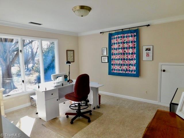 home office with light colored carpet and ornamental molding