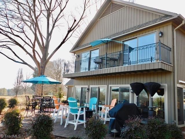 rear view of house with a balcony and a patio area