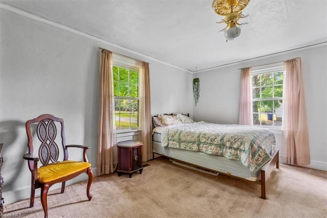 bedroom with crown molding, multiple windows, and light colored carpet