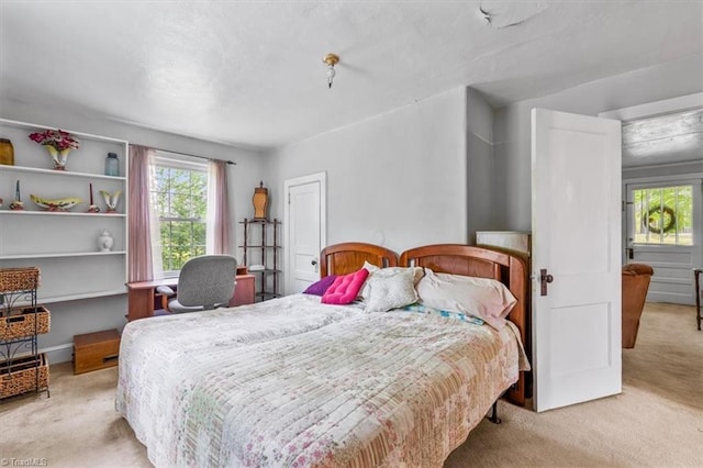 bedroom featuring light colored carpet