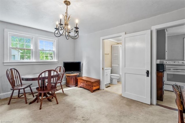 living area featuring an inviting chandelier, baseboards, and light colored carpet