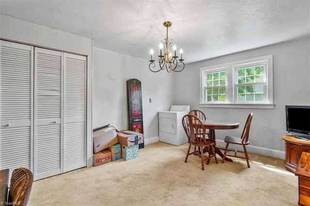 dining area with baseboards, carpet, washer / dryer, and a chandelier