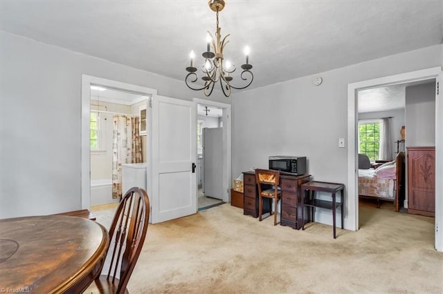 dining area with a notable chandelier and light colored carpet