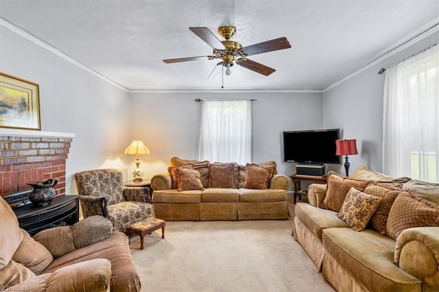 living room with a healthy amount of sunlight, crown molding, light carpet, and ceiling fan