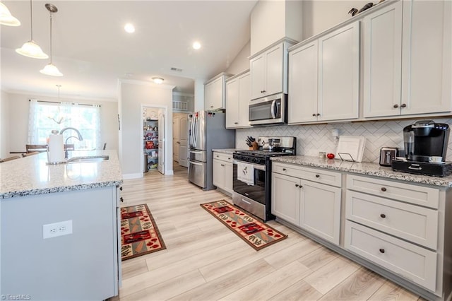 109 Red Maple Way, King, NC 27021 - kitchen featuring appliances with stainless steel finishes, a sink, backsplash, light wood-style floors, and ornamental molding