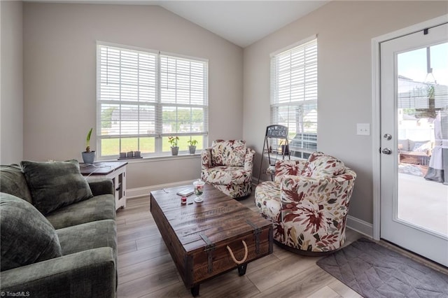 109 Red Maple Way, King, NC 27021 - living area with healthy amount of natural light, wood finished floors, vaulted ceiling, and baseboards