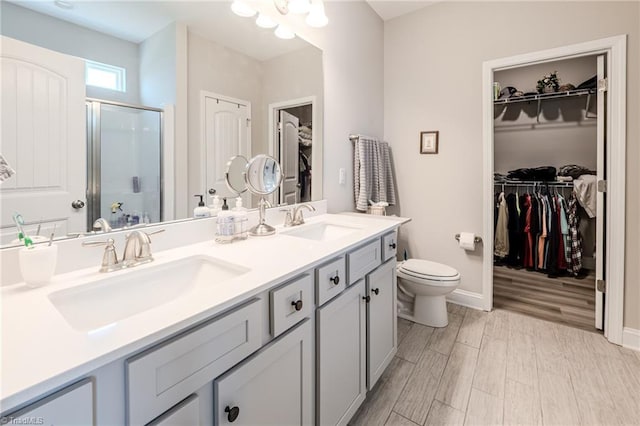 109 Red Maple Way, King, NC 27021 - bathroom with a stall shower, double vanity, a spacious closet, and toilet