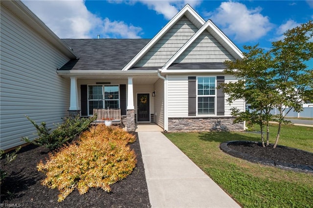 109 Red Maple Way, King, NC 27021 - entrance to property with stone siding, a yard, a porch, and a shingled roof