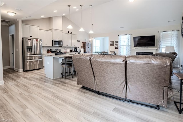 109 Red Maple Way, King, NC 27021 - living area featuring light wood-type flooring, high vaulted ceiling, a fireplace, recessed lighting, and baseboards