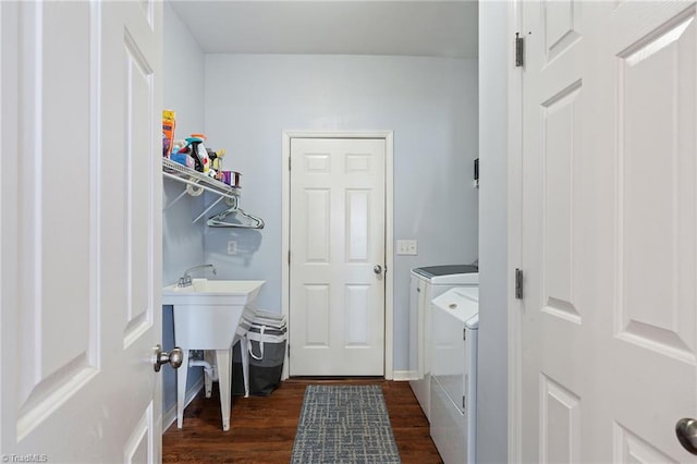 clothes washing area featuring separate washer and dryer and dark wood-type flooring