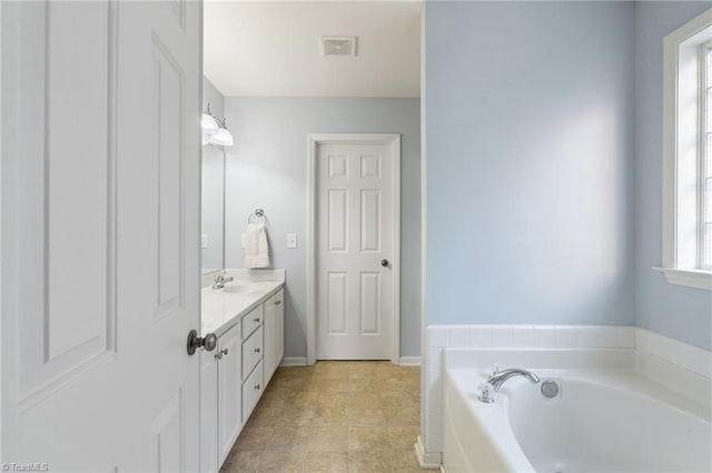 bathroom featuring vanity and a tub