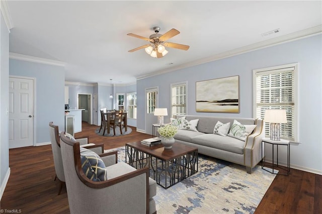 living room with crown molding, dark hardwood / wood-style floors, and ceiling fan