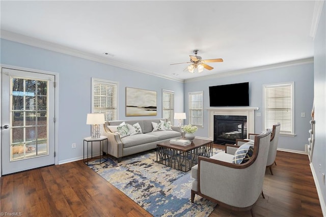 living room featuring crown molding, dark wood-type flooring, and a wealth of natural light