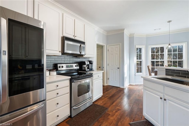 kitchen with crown molding, stainless steel appliances, backsplash, and white cabinets