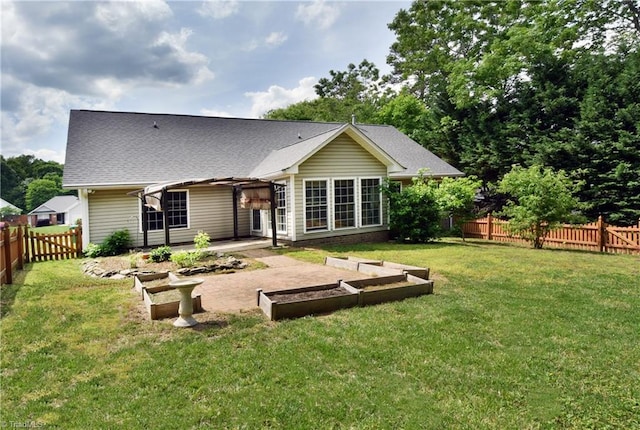 rear view of property featuring a patio, a fenced backyard, a lawn, and a vegetable garden