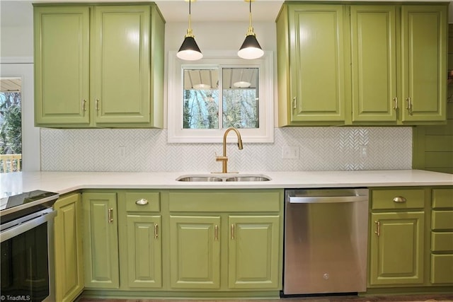 kitchen with stainless steel appliances, green cabinets, and a sink