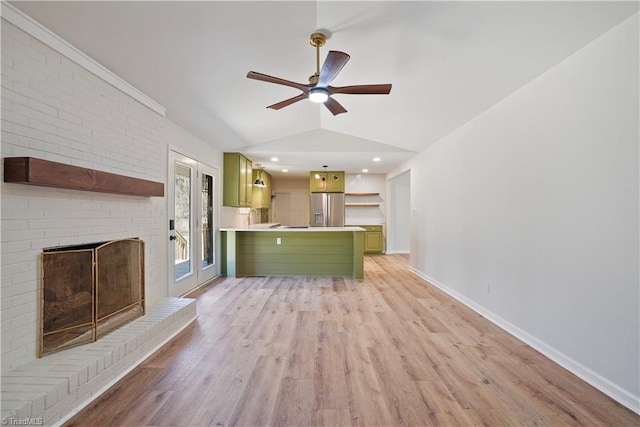 unfurnished living room with ceiling fan, baseboards, light wood-type flooring, lofted ceiling, and a fireplace