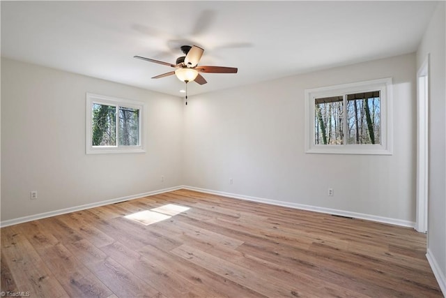 unfurnished room featuring baseboards, a ceiling fan, and wood finished floors