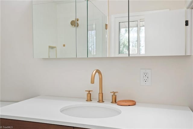 bathroom with an enclosed shower and vanity