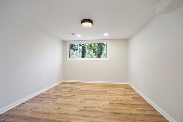 spare room with light wood-style flooring, recessed lighting, and baseboards