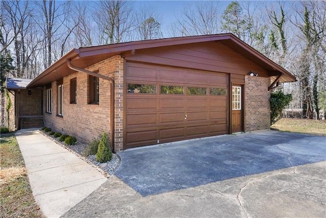 view of side of home with brick siding and a garage