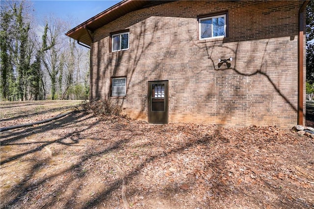 view of side of home with brick siding