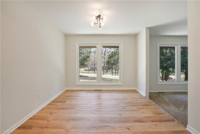 empty room with light wood-type flooring and baseboards