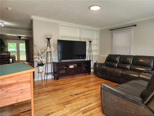 6905 Harlow Dr, Archdale, NC 27263 - living room with a textured ceiling, light wood finished floors, crown molding, built in features, and a baseboard heating unit