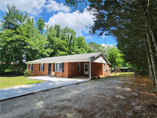 6905 Harlow Dr, Archdale, NC 27263 - ranch-style house with brick siding, driveway, a front yard, and an attached carport