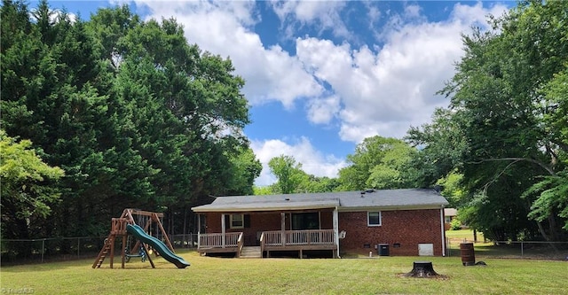6905 Harlow Dr, Archdale, NC 27263 - back of property with a playground, a deck, and brick siding